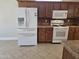 Spacious kitchen featuring stainless-steel refrigerator, gas range, and oak cabinets at 19595 N Sunburst Way, Surprise, AZ 85374