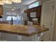 Kitchen with stainless appliances, natural light, and warm-colored wood cabinets at 19595 N Sunburst Way, Surprise, AZ 85374