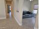 Living room with tile flooring that transitions to a connected Gathering room at 19595 N Sunburst Way, Surprise, AZ 85374