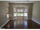 Open living room with hardwood floors and large windows creating a bright and airy space at 19595 N Sunburst Way, Surprise, AZ 85374