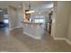 Spacious open-concept living area showcasing bar seating between kitchen and living room at 19595 N Sunburst Way, Surprise, AZ 85374