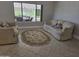 Inviting living room with comfortable seating and a view of the outdoor patio area at 19595 N Sunburst Way, Surprise, AZ 85374