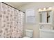 Clean bathroom with a seashell shower curtain and modern vanity at 1660 N 59Th St, Mesa, AZ 85205