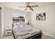 Comfortable bedroom with bright window, ceiling fan, and light-colored wood floors at 1660 N 59Th St, Mesa, AZ 85205