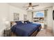 Cozy bedroom with two beds, neutral carpet, and a large arched window at 1660 N 59Th St, Mesa, AZ 85205