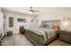Bedroom with hard floors, ceiling fan, and a large window view to pool at 1660 N 59Th St, Mesa, AZ 85205