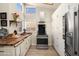 Modern kitchen features stainless steel appliances, light wood floors, butcher block countertops, and ample white cabinetry at 1660 N 59Th St, Mesa, AZ 85205