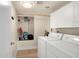 Functional laundry room with storage cabinets, and modern washer and dryer units at 1660 N 59Th St, Mesa, AZ 85205