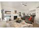 Comfortable living room with a fireplace, large windows overlooking the pool, and stylish furnishings, creating a welcoming space at 1660 N 59Th St, Mesa, AZ 85205