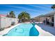 An inviting backyard pool area with mature palm trees and a serene desert landscape at 1660 N 59Th St, Mesa, AZ 85205