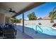 Inviting covered patio and pool area with mature landscaping, perfect for relaxing and entertaining outdoors at 1660 N 59Th St, Mesa, AZ 85205