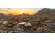Expansive aerial view of a hillside home nestled in a desert community at sunset at 24724 N 119Th Pl, Scottsdale, AZ 85255