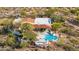 Aerial view of a desert home with a refreshing pool, charming landscaping, and relaxing seating area at 24724 N 119Th Pl, Scottsdale, AZ 85255