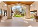 Charming patio with views of the lush green lawn, native desert vegetation, and blue skies at 24724 N 119Th Pl, Scottsdale, AZ 85255