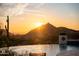 Backyard features a beautiful pool overlooking a desert landscape and a stunning orange sunset at 24724 N 119Th Pl, Scottsdale, AZ 85255