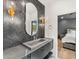 Chic bathroom with a concrete sink, black vanity and black herringbone tile accent wall provides great style at 24724 N 119Th Pl, Scottsdale, AZ 85255