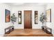 Entryway featuring hardwood floors, a wood door, and artwork on the walls at 24724 N 119Th Pl, Scottsdale, AZ 85255