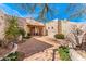 Inviting front entrance with a brick courtyard, wooden door, and classic Southwestern architectural details at 24724 N 119Th Pl, Scottsdale, AZ 85255