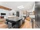 Bright kitchen with a skylight, hardwood floors, marble countertops, and modern stainless steel appliances at 24724 N 119Th Pl, Scottsdale, AZ 85255