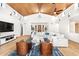 Bright living room boasts a wood plank ceiling, modern ceiling fan, white sectional sofa, and abundant natural light at 24724 N 119Th Pl, Scottsdale, AZ 85255