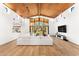 Bright open living room with a wood ceiling, hardwood floors, a large window, and a white couch at 24724 N 119Th Pl, Scottsdale, AZ 85255