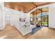 Bright living room boasts a wood plank ceiling, modern ceiling fan, white sectional sofa, and abundant natural light at 24724 N 119Th Pl, Scottsdale, AZ 85255