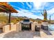 A built-in outdoor kitchen area is perfect for grilling and entertaining with mountain views at 24724 N 119Th Pl, Scottsdale, AZ 85255