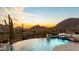 Arizona backyard with large pool overlooking beautiful desert landscape at sunset at 24724 N 119Th Pl, Scottsdale, AZ 85255