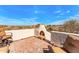 Spacious rooftop patio featuring a charming fireplace, scenic desert views, and comfortable outdoor seating at 24724 N 119Th Pl, Scottsdale, AZ 85255