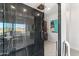 Modern walk-in shower with glass doors and black marble tile in the primary bathroom at 24724 N 119Th Pl, Scottsdale, AZ 85255