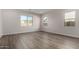 Spacious bedroom with hardwood floors and multiple windows at 16400 W Avenida Del Sol --, Surprise, AZ 85387
