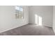 Spacious bedroom with neutral-toned carpet and large window at 16400 W Avenida Del Sol --, Surprise, AZ 85387