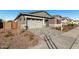 New construction home with a two-car garage and curb appeal at 16400 W Avenida Del Sol --, Surprise, AZ 85387