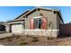 New construction home with a stone facade and red shutters at 16400 W Avenida Del Sol --, Surprise, AZ 85387