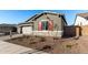 New home with a landscaped front yard and stone accents at 16400 W Avenida Del Sol --, Surprise, AZ 85387