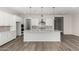 Open concept kitchen with white cabinets, island, and stainless steel appliances at 16400 W Avenida Del Sol --, Surprise, AZ 85387