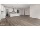 Open concept kitchen and living area with hardwood floors at 16400 W Avenida Del Sol --, Surprise, AZ 85387