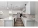 White kitchen with an island, stainless steel appliances, and white subway tile at 16400 W Avenida Del Sol --, Surprise, AZ 85387
