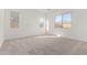 Bright bedroom with neutral carpeting and large windows at 16412 W Avenida Del Sol --, Surprise, AZ 85387