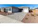 New construction home with a two-car garage and a brick paved driveway at 16412 W Avenida Del Sol --, Surprise, AZ 85387