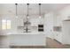 Modern kitchen with white cabinets, quartz countertops, and stainless steel appliances at 16412 W Avenida Del Sol --, Surprise, AZ 85387