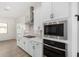 Modern kitchen with white cabinets, stainless steel appliances, and gas cooktop at 16412 W Avenida Del Sol --, Surprise, AZ 85387