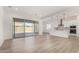Open concept living room with sliding glass doors and kitchen view at 16412 W Avenida Del Sol --, Surprise, AZ 85387