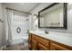 Clean bathroom with wood vanity, tiled shower, and bathtub at 7950 E Keats Ave # 133, Mesa, AZ 85209