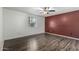 Spacious bedroom with dark wood floors and a red accent wall at 7950 E Keats Ave # 133, Mesa, AZ 85209