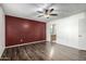 Bright bedroom with dark wood floors and a red accent wall at 7950 E Keats Ave # 133, Mesa, AZ 85209