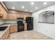 Kitchen features wood cabinets, black appliances, and a breakfast bar at 7950 E Keats Ave # 133, Mesa, AZ 85209