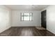 Living room featuring wood-look flooring and a dark brown door at 7950 E Keats Ave # 133, Mesa, AZ 85209