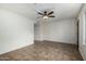 Living room with dark brown door and tile flooring, and a ceiling fan at 7950 E Keats Ave # 133, Mesa, AZ 85209