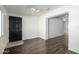 Living room with wood-look flooring and a dark brown door at 7950 E Keats Ave # 133, Mesa, AZ 85209